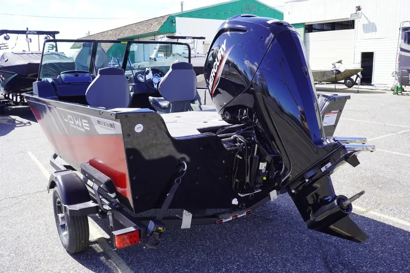 Slide: The Image of 2026 Lowe Fishing Machine 1675 WT with Mercury outboard motor in parking lot. - 7