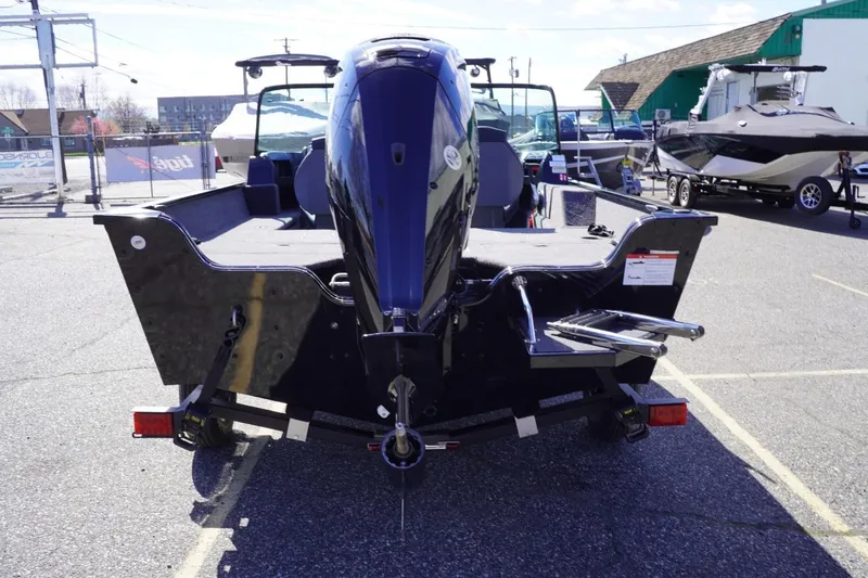 Slide: The Image of 2026 Lowe Fishing Machine 1675 WT boat, rear view in a parking lot. - 8