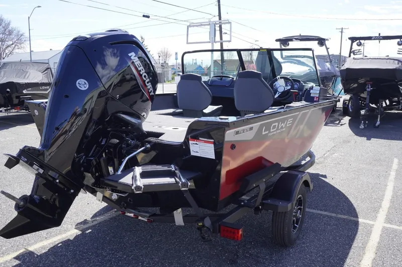 Slide: The Image of 2026 Lowe Fishing Machine 1675 WT with Mercury engine, parked outdoors on a trailer. - 9