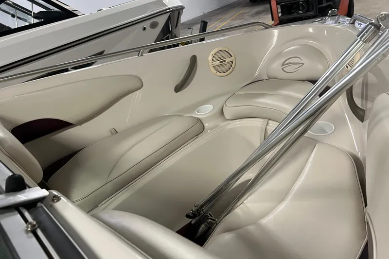 Slide: The Image of 2003 Crownline 192 BR boat interior with beige seating and stainless steel accents. - 3