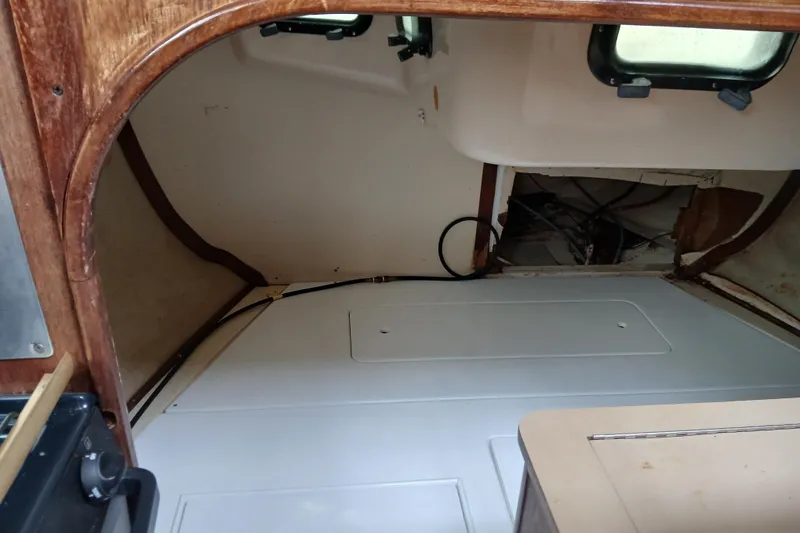 Slide: The Image of Interior cabin view of a 1994 Hunter 30 sailboat, showcasing wooden and white paneling. - 10