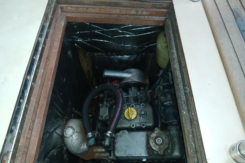 Slide: The Image of Engine compartment of a 1994 Hunter 30 sailboat, showing mechanical components and insulation. - 14