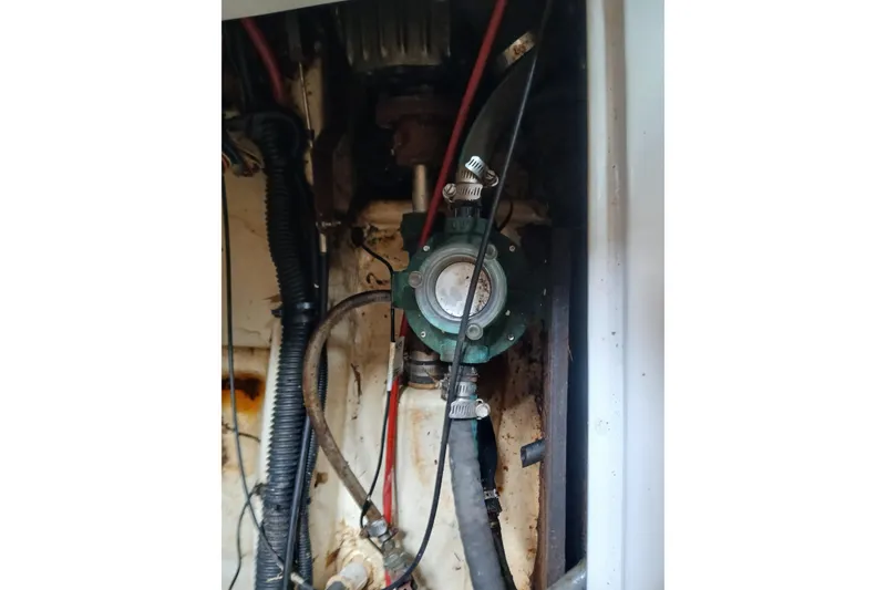 Slide: The Image of Engine compartment of a 1994 Hunter 30 sailboat, showing hoses and mechanical components. - 16