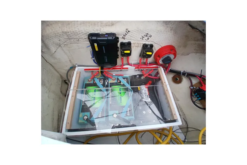 Slide: The Image of Electrical system setup in a 1994 Hunter 30 boat, featuring batteries and wiring. - 18