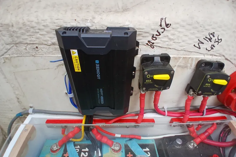 Slide: The Image of Renogy MPPT charge controller setup on 1994 Hunter 30 boat with wiring and circuit breakers. - 19