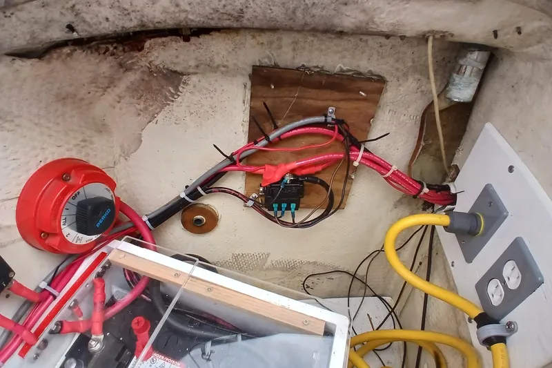 Slide: The Image of Electrical wiring setup in a 1994 Hunter 30 boat, featuring switches and cables. - 20