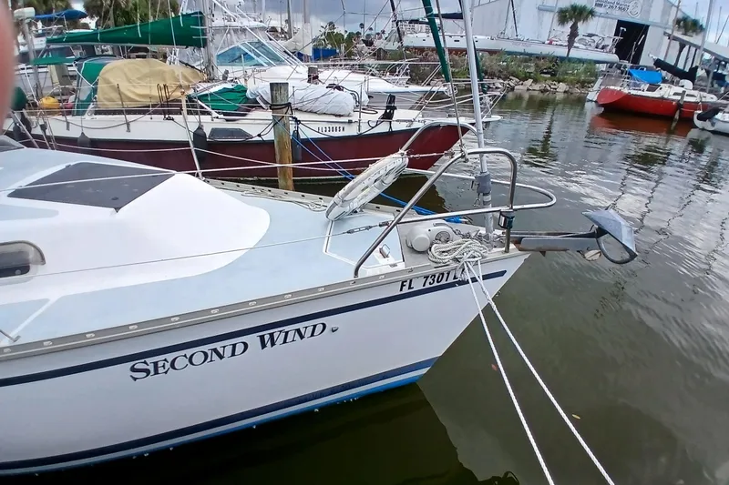 Slide: The Image of Hunter 30 sailboat named "Second Wind" docked in a marina, 1994 model. - 24