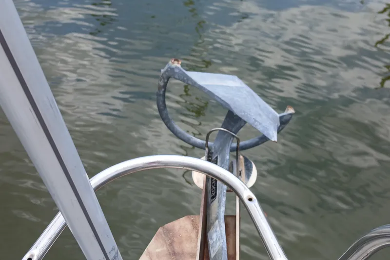 Slide: The Image of Anchor on a 1994 Hunter 30 sailboat, positioned over calm water. - 26