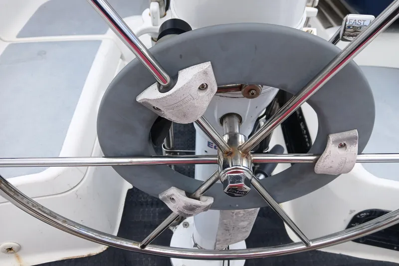 Slide: The Image of Steering wheel of a 1994 Hunter 30 sailboat with protective cover and metal spokes. - 29