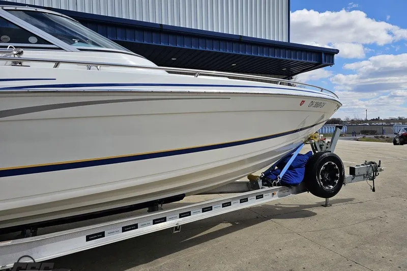 Slide: The Image of 2008 Formula 271 FASTech boat on trailer, parked outdoors under a blue sky. - 11