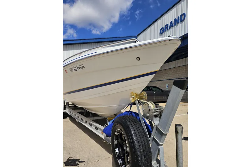 Slide: The Image of 2008 Formula 271 FASTech boat on trailer, parked outside a building under a blue sky. - 13