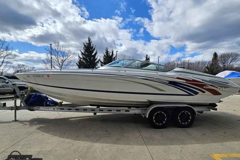 Slide: The Image of 2008 Formula 271 FASTech boat on trailer under a partly cloudy sky. - 18
