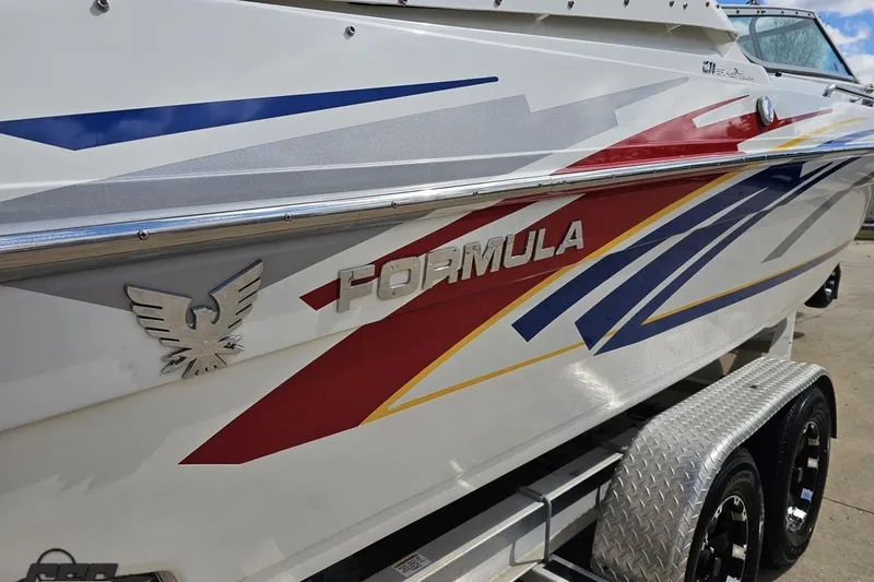 Slide: The Image of 2008 Formula 271 FASTech boat with colorful graphics and logo on trailer. - 27
