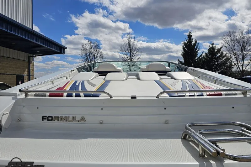 Slide: The Image of 2008 Formula 271 FASTech boat with colorful upholstery, parked outdoors under a blue sky. - 30