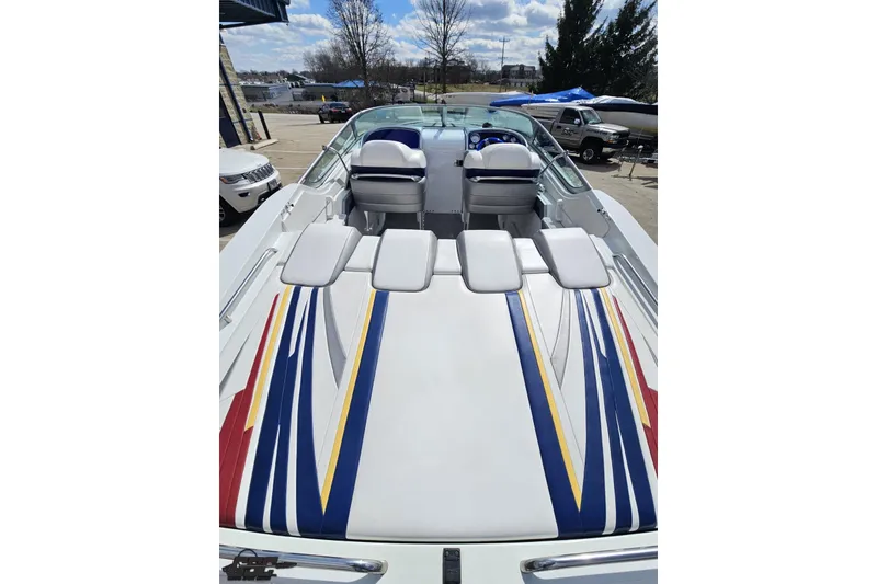 Slide: The Image of 2008 Formula 271 FASTech boat with colorful striped upholstery, docked outdoors. - 34