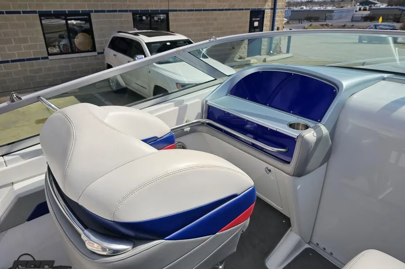 Slide: The Image of 2008 Formula 271 FASTech boat interior with white and blue seating, docked near a building. - 44