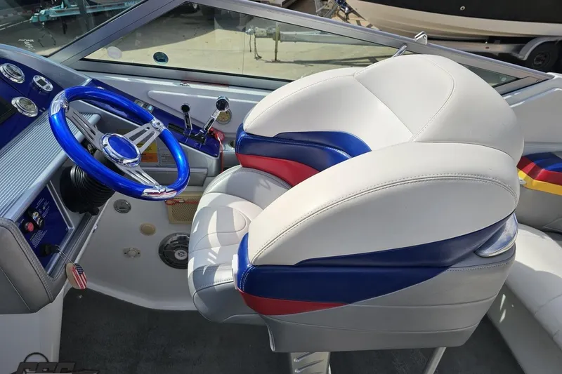 Slide: The Image of Interior of a 2008 Formula 271 FASTech boat with blue steering wheel and white seating. - 48