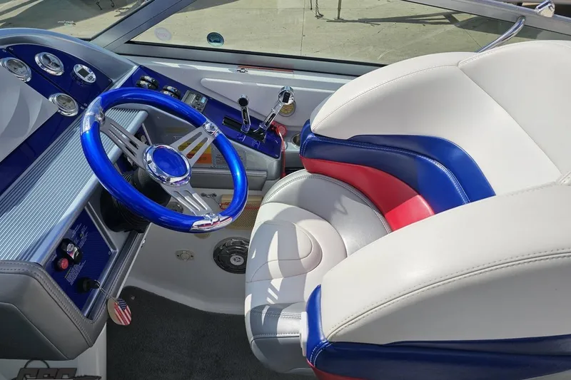 Slide: The Image of Interior of 2008 Formula 271 FASTech boat with blue steering wheel and colorful seating. - 49