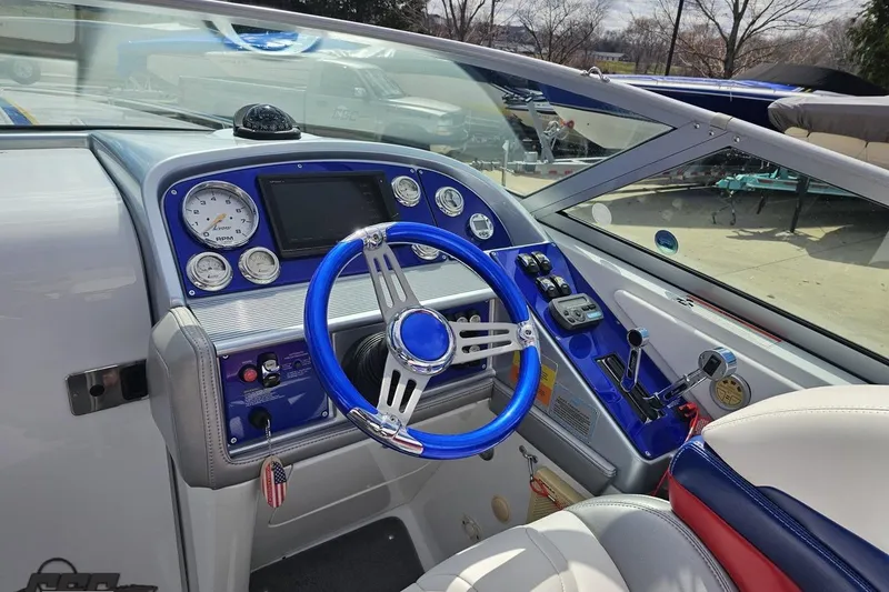 Slide: The Image of 2008 Formula 271 FASTech boat cockpit with blue steering wheel and modern dashboard controls. - 51