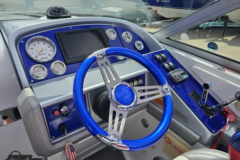 Slide: The Image of 2008 Formula 271 FASTech boat dashboard with blue steering wheel and modern gauges. - 52