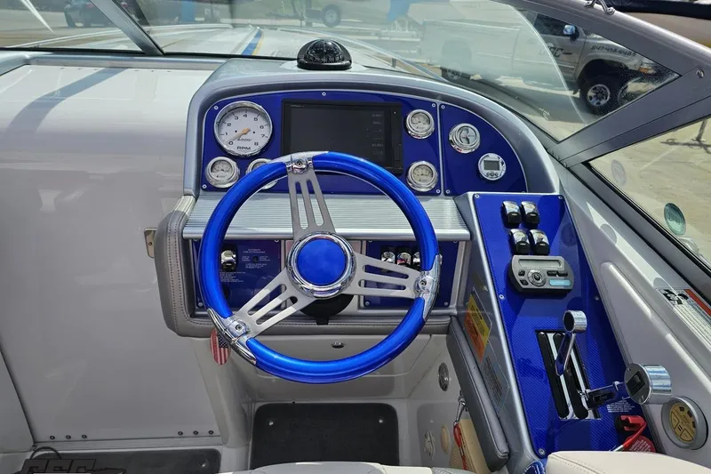 Slide: The Image of Cockpit of a 2008 Formula 271 FASTech boat with blue steering wheel and gauges. - 53