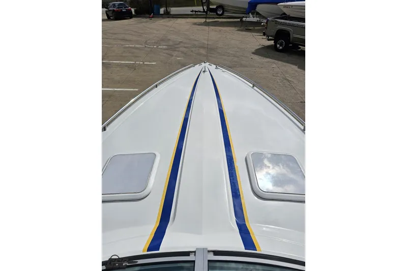 Slide: The Image of 2008 Formula 271 FASTech boat with blue and yellow stripes on deck. - 58