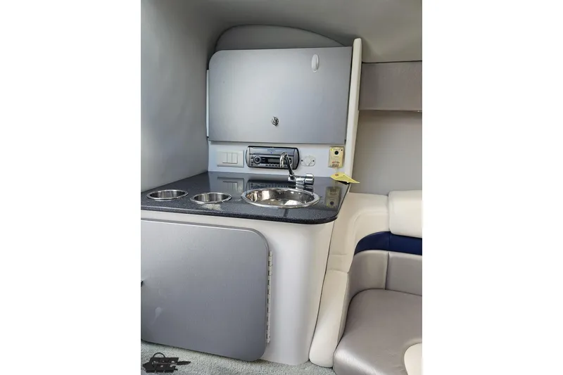 Slide: The Image of Interior of 2008 Formula 271 FASTech boat featuring a compact kitchenette with sink and storage. - 66