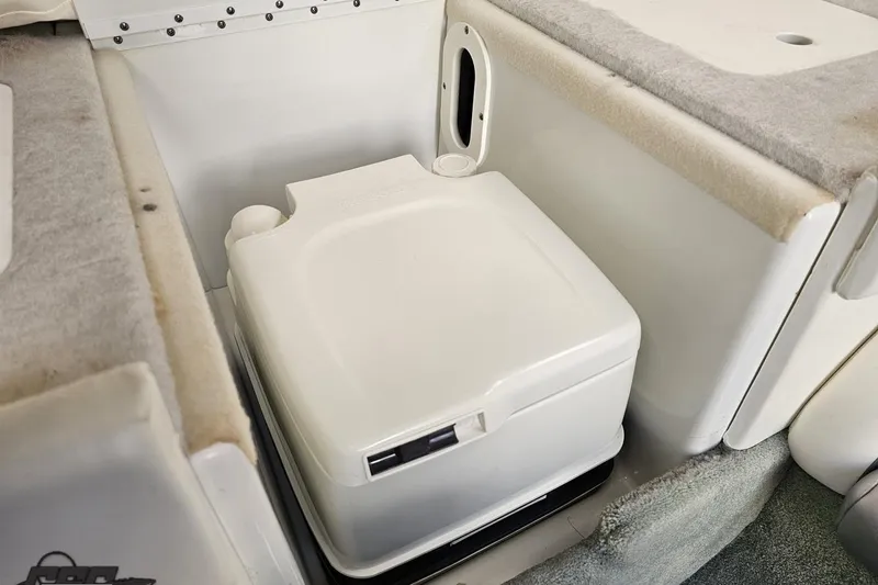Slide: The Image of Portable toilet in 2008 Formula 271 FASTech boat interior, featuring compact design and carpeted surroundings. - 71