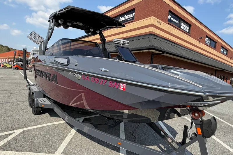 Slide: The Image of 2023 Supra SL 550 boat parked outside a dealership on a sunny day. - 10