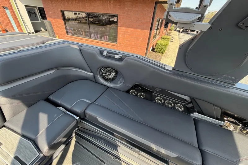 Slide: The Image of 2023 Supra SL 550 boat interior with sleek seating and modern speaker system. - 17