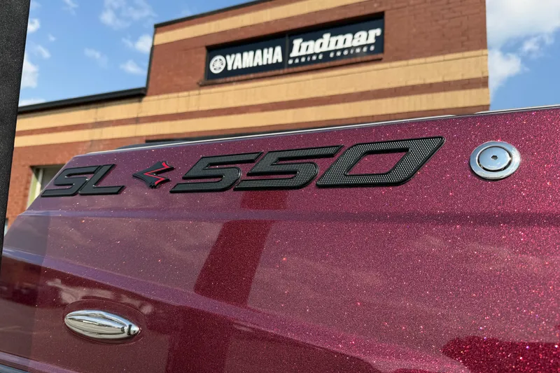 Slide: The Image of 2023 Supra SL 550 boat with Yamaha Indmar building in background. - 2