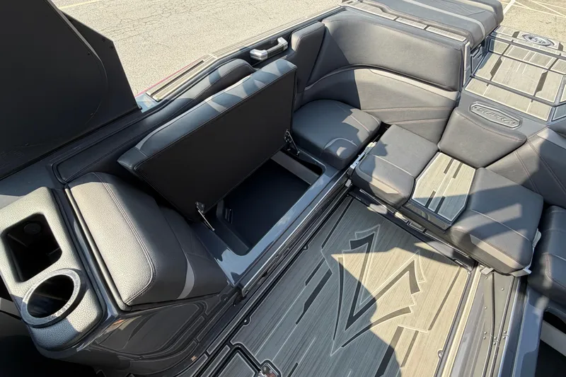 Slide: The Image of 2023 Supra SL 550 interior with open storage compartment and cup holder. - 20