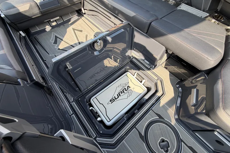 Slide: The Image of 2023 Supra SL 550 interior with storage compartment and branded cooler. - 25