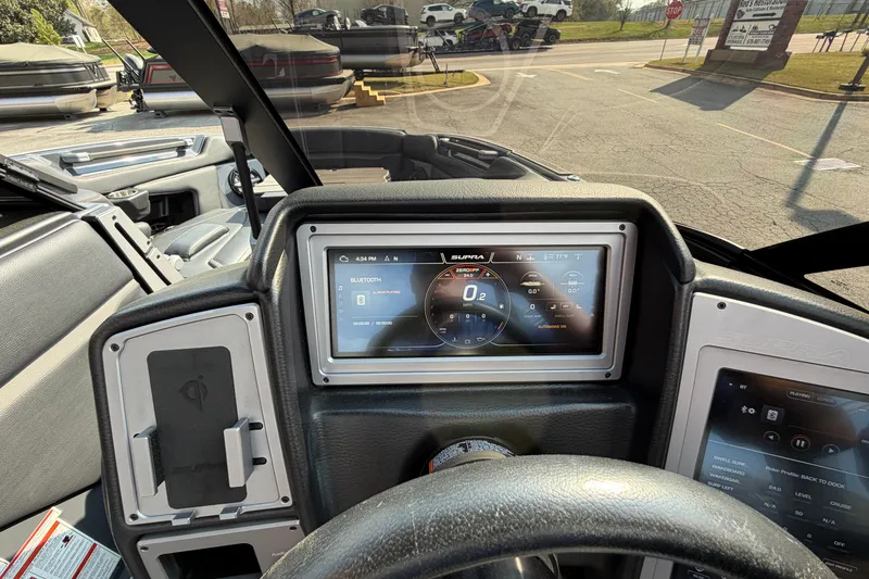 Slide: The Image of Interior dashboard of 2023 Supra SL 550 boat with digital display and controls. - 26