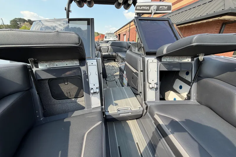 Slide: The Image of 2023 Supra SL 550 boat interior with open storage compartments and seating. - 31
