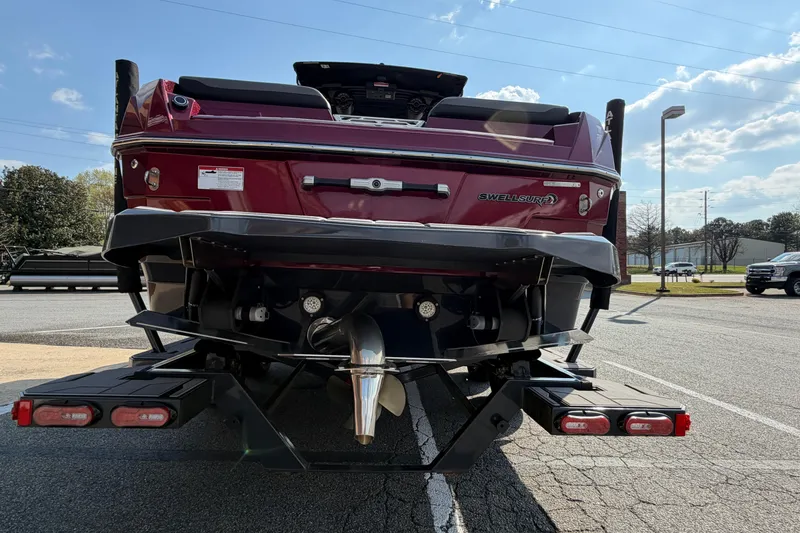 Slide: The Image of 2023 Supra SL 550 boat rear view with Swell Surf system in parking lot. - 4