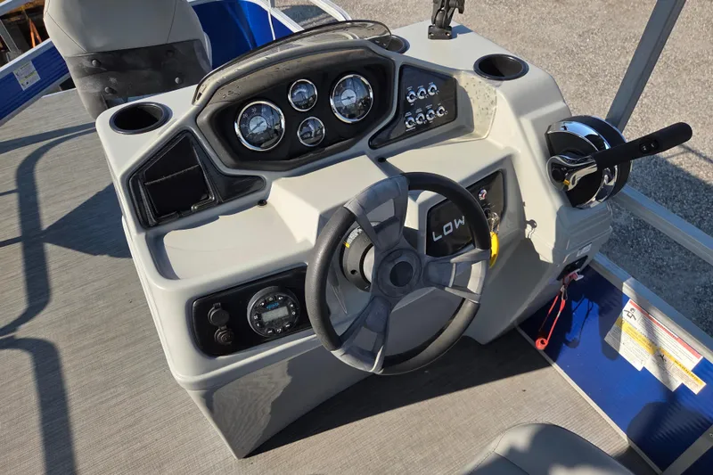 Slide: The Image of Steering console of 2022 Lowe SF 194 Sport Fish boat with gauges and controls. - 12