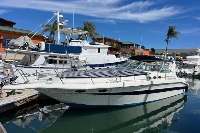 Slide: The Image of 1994 Sea Ray Sundancer 400 docked, featuring a spacious teak swim platform and cooler. - 10
