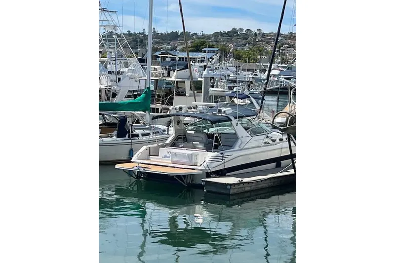Slide: The Image of 1994 Sea Ray Sundancer 400 yacht docked in a marina with American flag. - 2