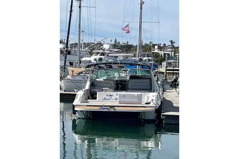 Slide: The Image of 1994 Sea Ray Sundancer 400 yacht docked at marina under clear blue sky. - 3