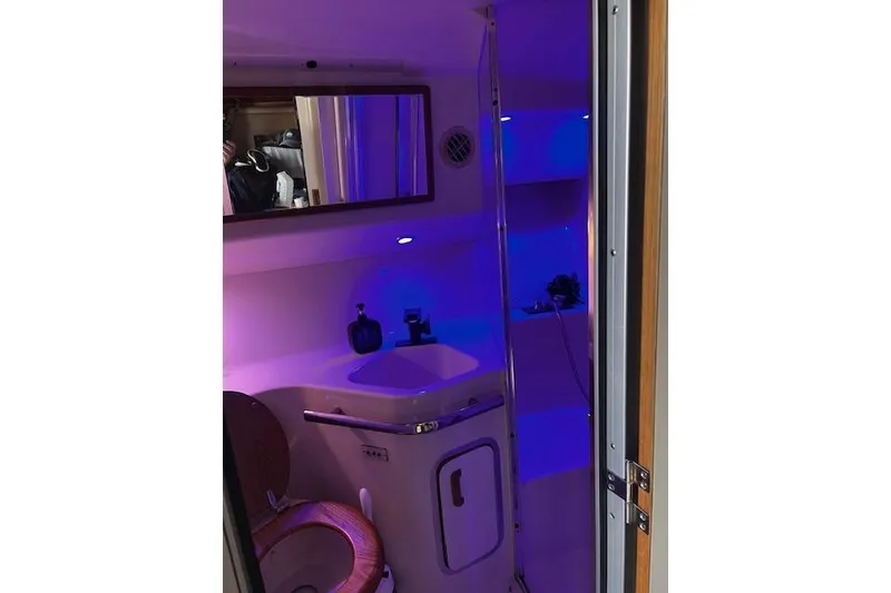 Slide: The Image of Bathroom interior of 1994 Sea Ray 400 Express Cruiser with purple lighting. - 36