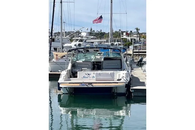 Slide: The Image of 1994 Sea Ray Sundancer 400 docked at marina under clear blue sky. - 4