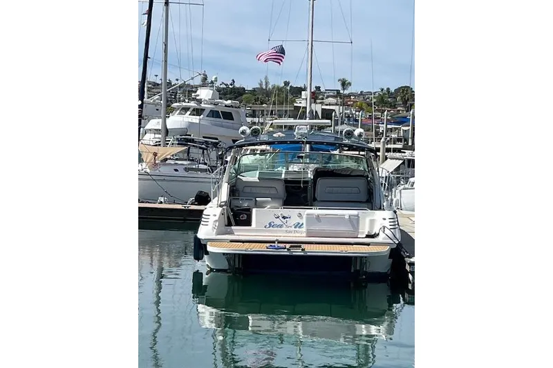 Slide: The Image of 1994 Sea Ray Sundancer 400 yacht docked in a marina under a clear blue sky. - 5