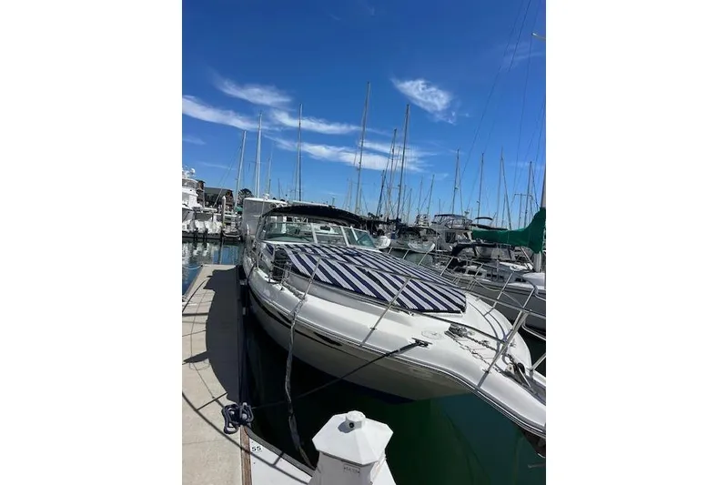 Slide: The Image of 1994 Sea Ray Sundancer 400 yacht docked in marina, featuring logo and charter vessel decal. - 7