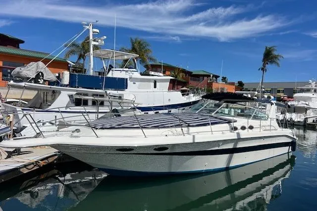 Slide: The Image of 1994 Sea Ray Sundancer 400 interior with white seating, docked at marina. - 9