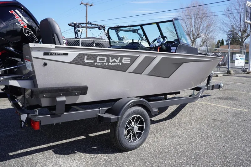 Slide: The Image of 2026 Lowe Fishing Machine 1775WT boat on trailer, parked outdoors. - 10