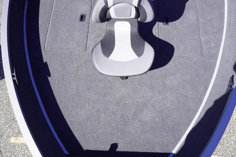 Slide: The Image of 2026 Lowe Fishing Machine 1775WT boat interior with gray carpet and swivel seat. - 13