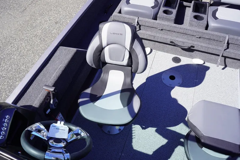 Slide: The Image of 2026 Lowe Fishing Machine 1775WT interior with steering wheel and seating. - 18
