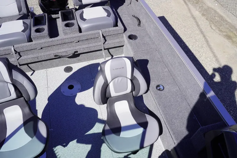 Slide: The Image of 2026 Lowe Fishing Machine 1775WT interior with gray seating and storage compartments. - 19