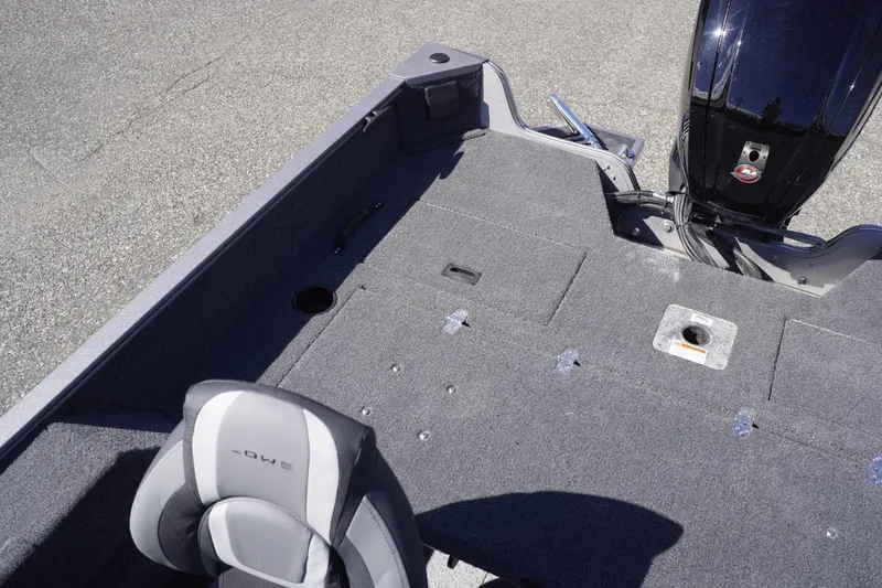 Slide: The Image of 2026 Lowe Fishing Machine 1775WT boat interior with seating and motor view. - 22